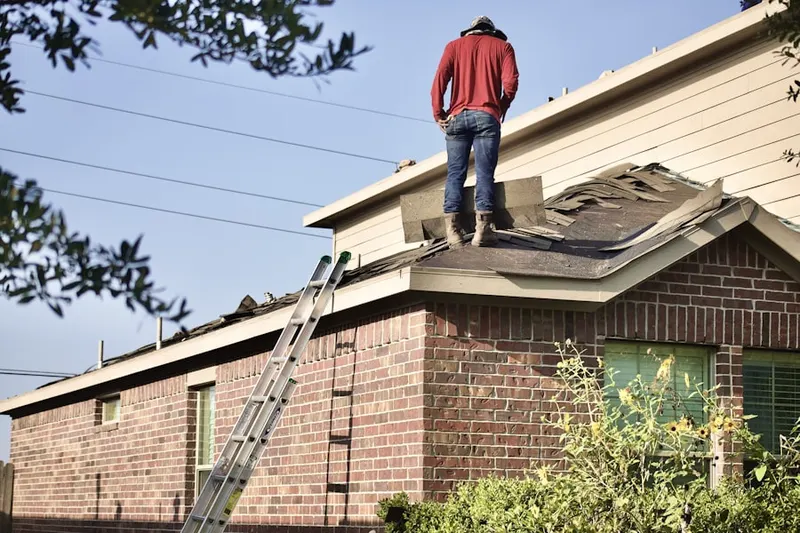 Professional roofer working on a residential roof in Marcott Woods